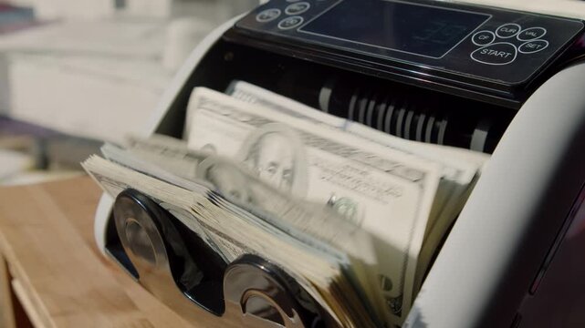 Watch as fresh stacks of cash flow effortlessly through a modern money counting machine inside a cozy cafe, blending technology with everyday life