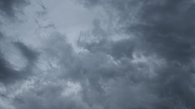Timelapse of blue-gray evening clouds moving across a blue sky

