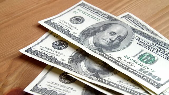 In a warm, inviting room, expert hands skillfully sort and count crisp bills, creating a mesmerizing dance of cash that captures the essence of money's value