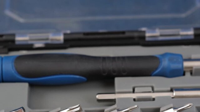 A set of metal bits for installation work in a plastic case.