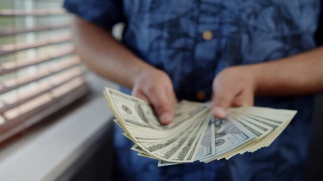 Hands tenderly count crisp banknotes in a bright, inviting space. Each bill carries promises of new beginnings and thrilling adventures ahead