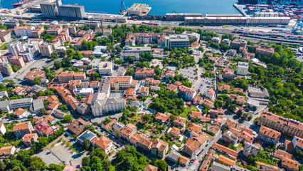Obraz premium Aerial view of Rijeka, Croatia, showcasing its vibrant port, dense urban landscape, and the beautiful Kvarner Gulf under a clear blue sky. Banderovo