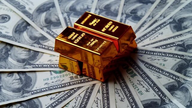 Golden bars rest elegantly atop a fan of crisp dollar bills, creating a striking contrast that embodies prosperity and success in a lavish setting