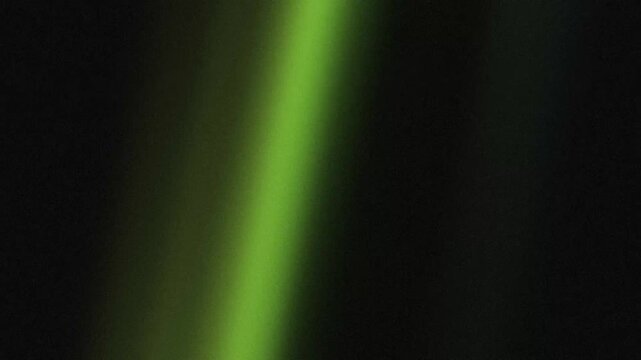 Abstract green light beam shimmering with organic film grain in a dark cinematic atmosphere featuring vintage analog texture and neon glow