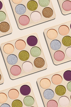 Minimal pattern with repeat makeup powder palette with sparkling and matte eyeshadows refills round shape in geometric composition. Contemporary beauty concept, neutral beige background, pastel color.