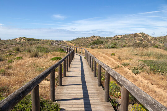Wooden walkway leading to Bordeira Beach, Algarve, Portugal