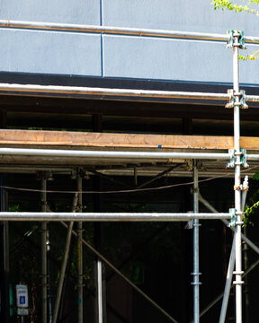Steel pipes in front of a building that is being remodeled or redesigned. 