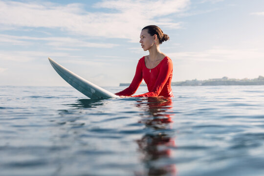 Surfer woman on surfboard in ocean. Surfer woman in water