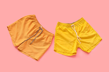Naklejka premium Swimming trunks on pink background