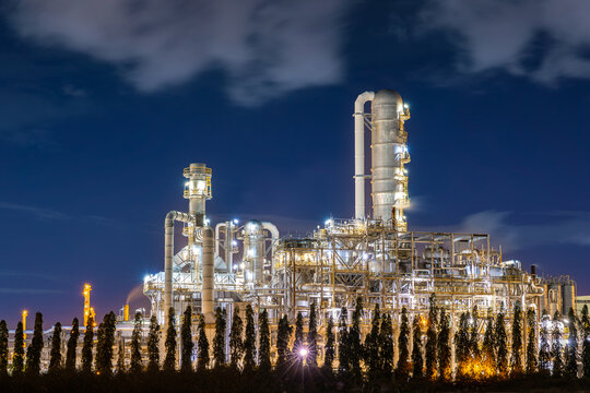 oil refinery petrochemical plant oil gas and energy production with flare stack smoke pollution emission, chemical and polymer production engineering technology for climate change after sunset time