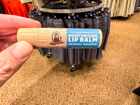 Chandler, Arizona - May 30, 2026: Hand holds a Dr Squatch brand men's lip balm