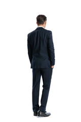 Naklejka premium Back view of elegant man standing with hands in pockets