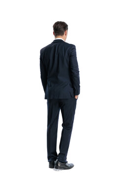 Back view of elegant man standing with hands in pockets
