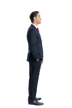 Side view of elegant man standing with hands in pockets