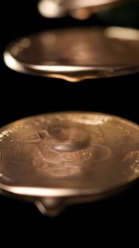 Luxurious golden paint gathers into a thick droplet on an upper edge before falling downward and striking a glowing bitcoin below creating ripples and spreading across the textured metallic surface