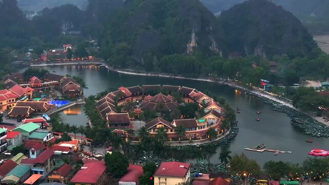 Aerial view of Tam Coc, a Historic Old Town Island in evening, Surrounded by Carst Mountains in Ninh Binh, Vietnam.