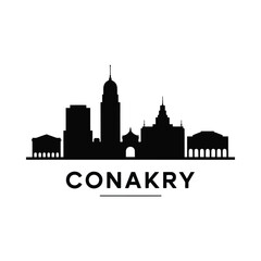 Naklejka premium Conakry Skyline Silhouette Against White Background cityscape