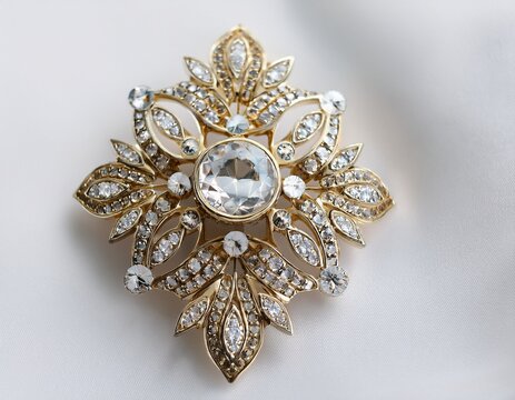 elegant antique brooch embellished with sparkling rhinestones on a white background