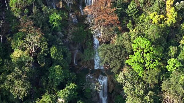 Aerial view of a Beautiful Kuang Si Waterfall in Luang Prabang, Laos. Top View Drone Shot of Lush Jungle in Lao.