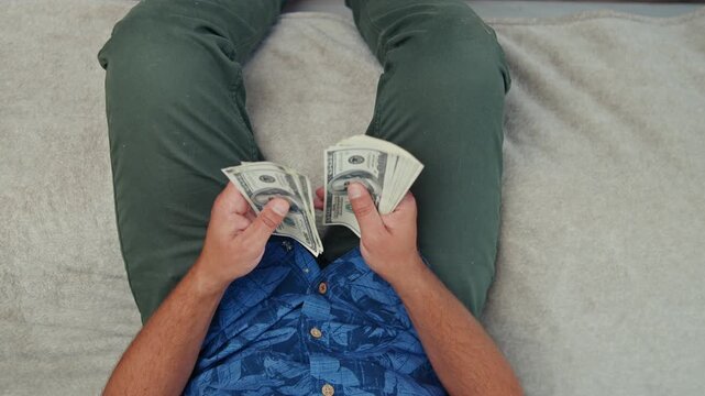 Hands skillfully sort and count crisp Canadian dollar bills, filling the warm atmosphere of a comfortable room with a steady rhythm of financial focus and precision