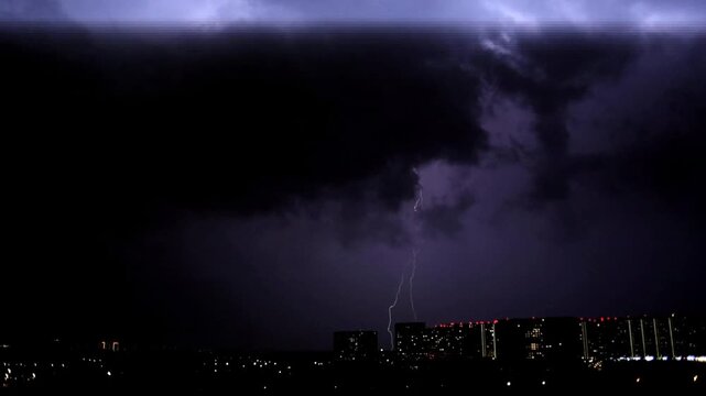 A severe thunderstorm in a black sky. A hurricane and lightning in the night sky.