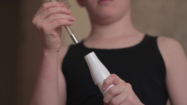 A teenager uses a Darsonval device, switching the attachment. Professional skincare at home. Teenage skin issues during hormonal changes. High quality FullHD footage