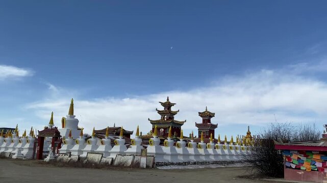 Ornate Vache Stupas (Waqie Talin) draped with colorful prayer flags at Zoig&ecirc; Marsh, showcasing Tibetan Buddhist heritage, sacred architecture, and spiritual culture in Amdo.