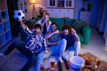 Friends cheering football game on tv at home © Zoran Jesic
