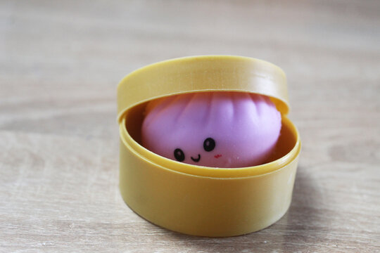 A small anti-stress toy squishy in the shape of a dumpling is in a box