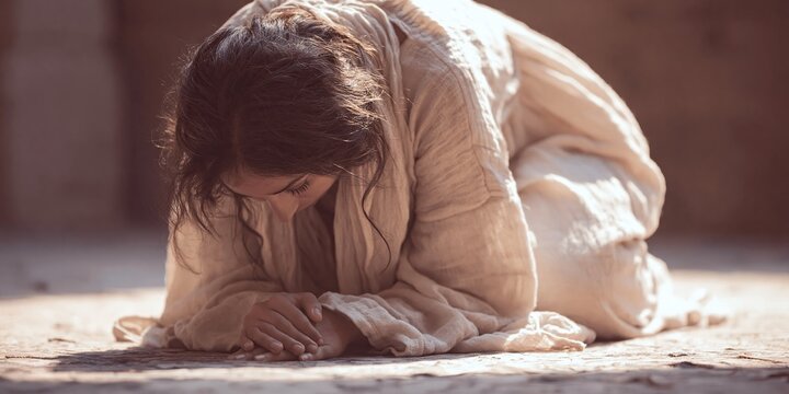 woman kneeling and bowing to worship her god