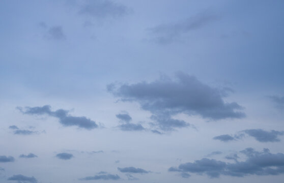 Overcast sky background with scattered grey cumulus clouds and copy space