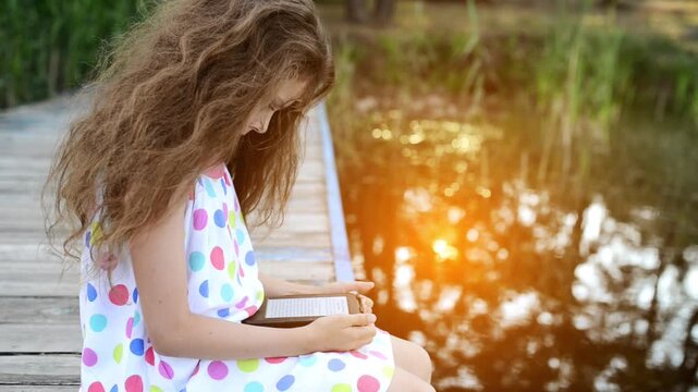 Little beautiful girl read e-books