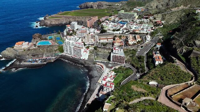Aerial birds eye circling view of Playa de San Marcos, Tenerife