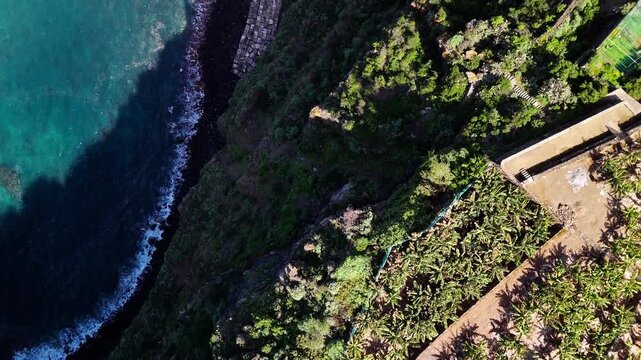 Top down drone view of volcanic cliffs at Playa de San Marcos, Tenerife