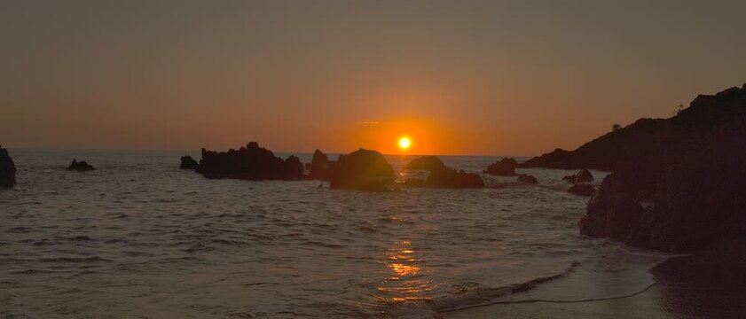 Volcanic coast wave crashing rocks at sunset Scalea Calabria Italy

