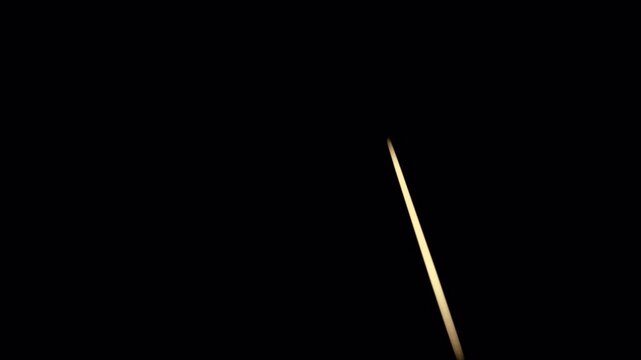 Abstract dark background with floating white particles moving in space.