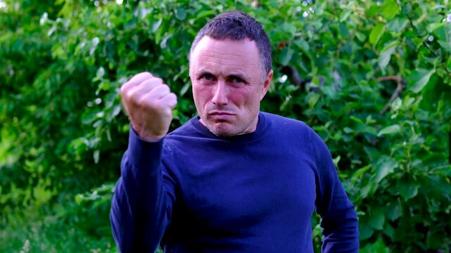 Intense body language and a raised fist reveal frustration and irritation. scene captures conflict aggression dissatisfaction emotional stress and a powerful reaction to an unpleasant situation.