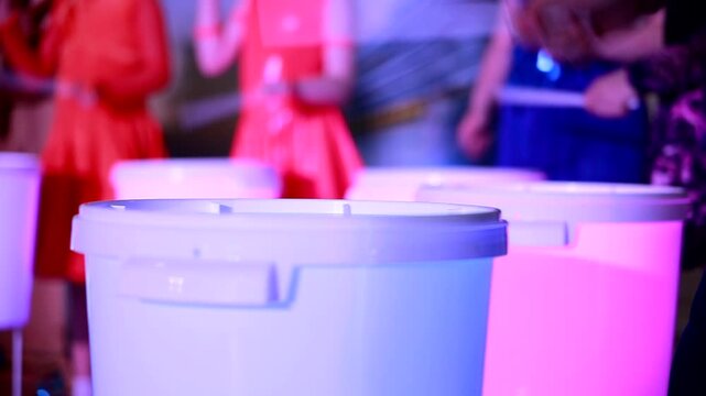 Epic performance of drummers on illuminated drums. Drum show. Drum ensemble. Close-up. slow motion