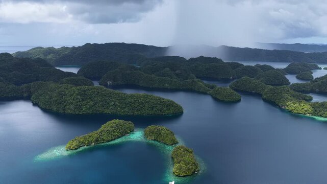 Low rain clouds drift over Palau's scenic Rock Islands. This tiny and beautiful island-nation is a popular destination for divers, snorkelers, kayakers, and World War II buffs. 
