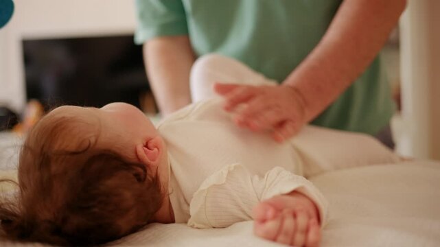 Adorable infant lying on a padded surface during supervised tummy time exercise