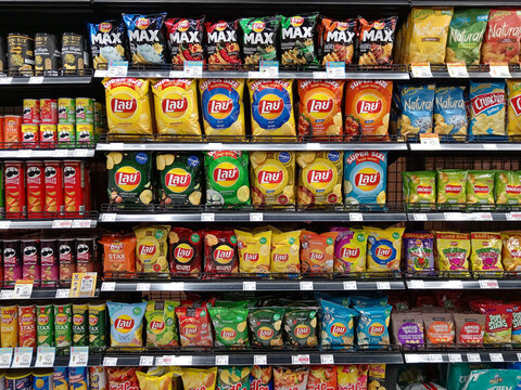 Variety of Ultra Processed Junk Food Potato Chips on Display at Grocery Store