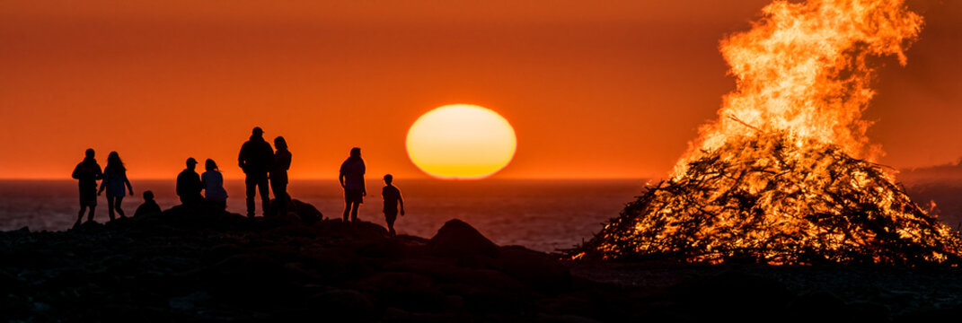 Scenic Sunset Bonfire Gathering: Silhouettes, Nature, and Warmth in Evening Celebration