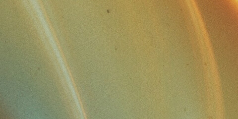 Saturn s rings a grainy photo of the planetary rings with a yellow orange hue © Nasrin