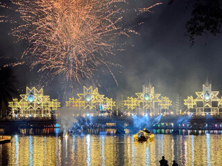 Fireworks exploding over Nawarat Bridge at night in Chiang Mai