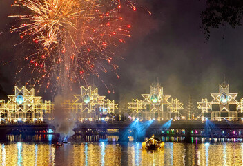 Fireworks exploding over Nawarat Bridge at night in Chiang Mai