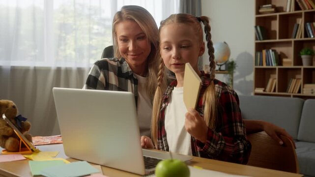 Caucasian family little girl mother greeting video call laptop showing notebook happy child talking schoolgirl daughter kid waving hand online conference e-learning mom female woman at home education