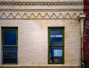 Obraz premium Ornate Brick Work on a Vintage Building with Leaded Glass Windows.