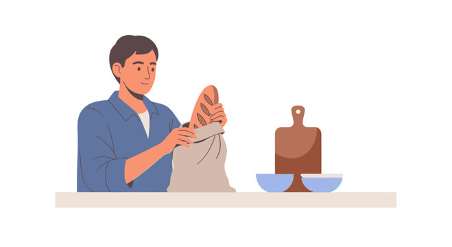 Man unpacking fresh bread from grocery bag at kitchen counter with bowls and cutting board