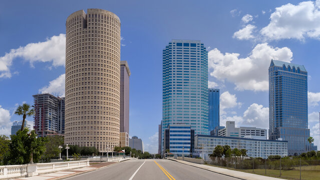 A panoramic view looking down the road of the Kennedy Boulevard Bridge toward skyscrapers and high rise office towers in the downtown city center of Tampa