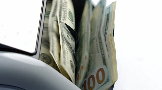 Cash bills glide effortlessly into a sleek machine, bringing excitement to bank employees who rely on accurate counting to serve customers efficiently